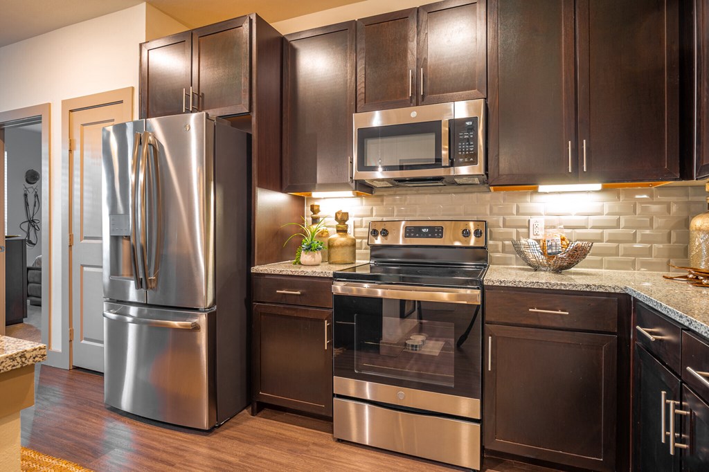 a kitchen with stainless steel appliances and wooden cabinets