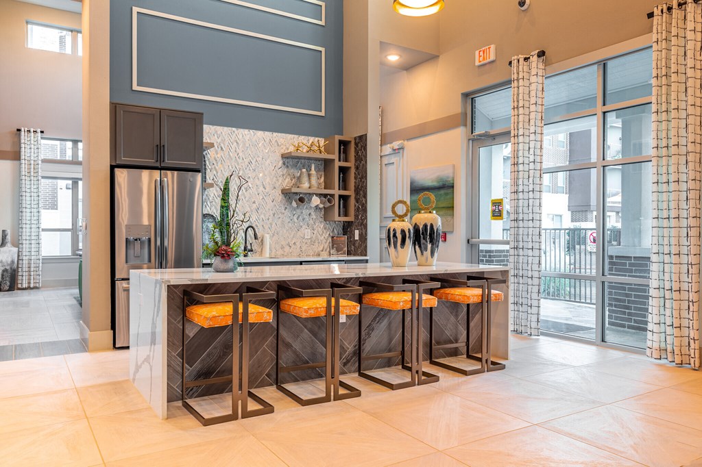 a kitchen with a large island with four stools