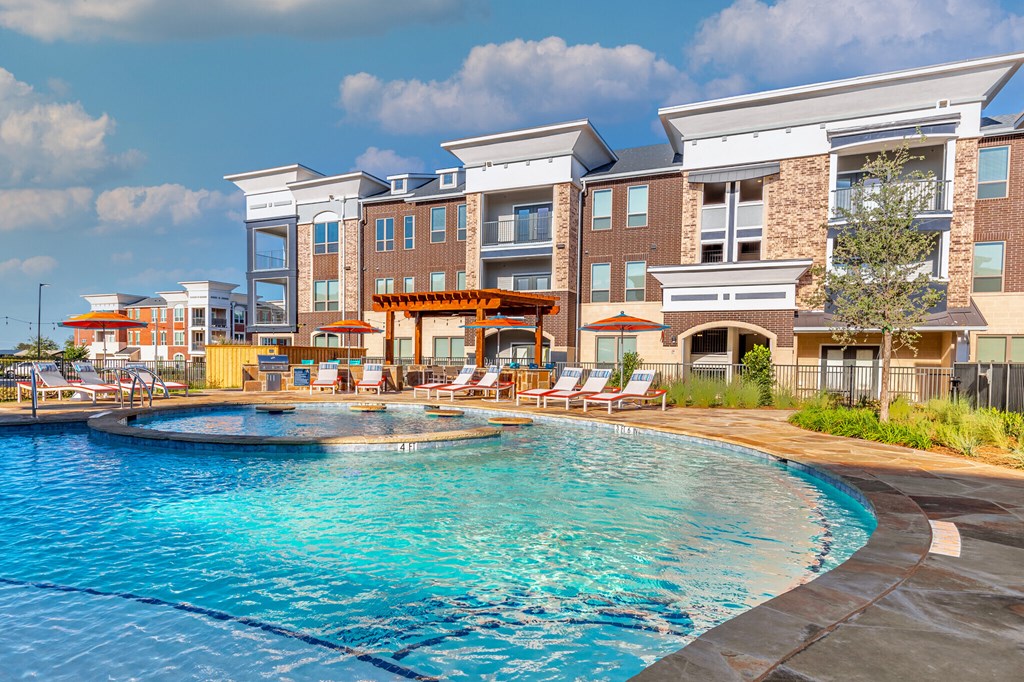 a swimming pool with a building in the background
