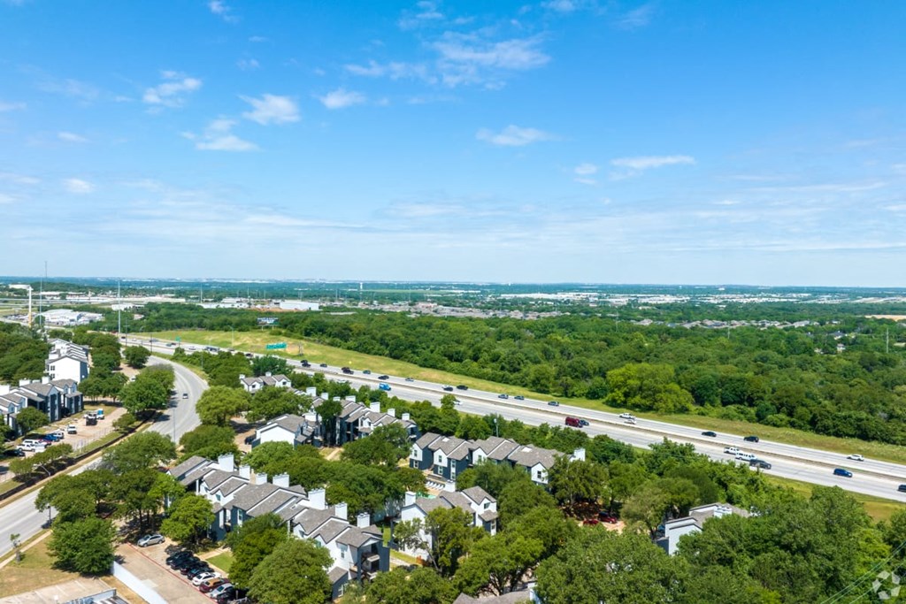 A suburban area with houses and a highway.