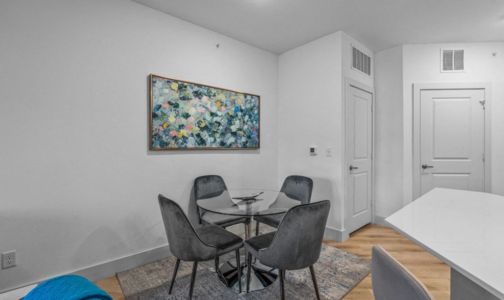 a dining room with a table and chairs