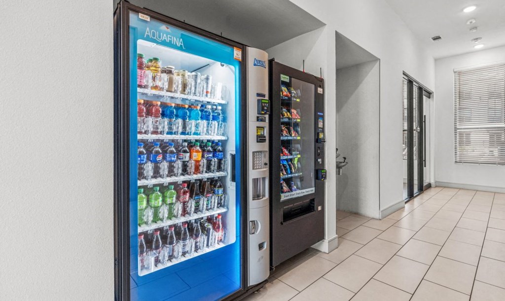 a refrigerator with soda and drinks in a lobby