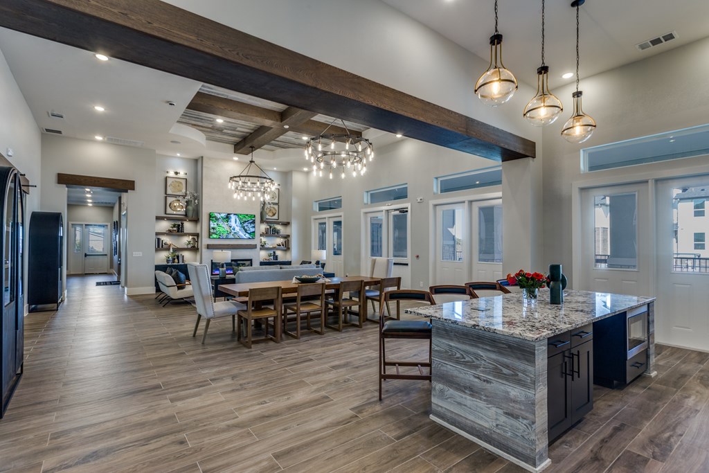 A modern kitchen with a large island and a dining area.