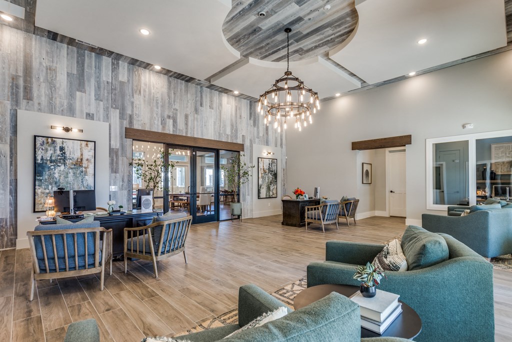 A modern living room with a dining area and a kitchen in the background.