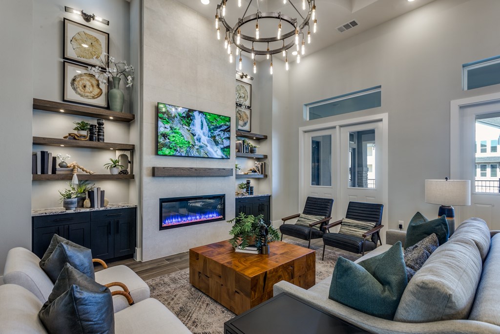 A modern living room with a fireplace and a flat screen TV mounted on the wall.