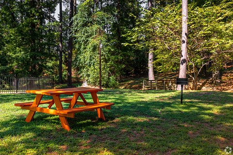 a picnic table in a park with trees