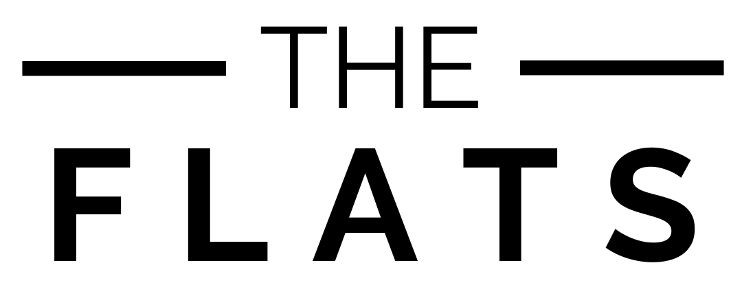 The image displays the words "THE FLATS" in bold, black letters on a green background.