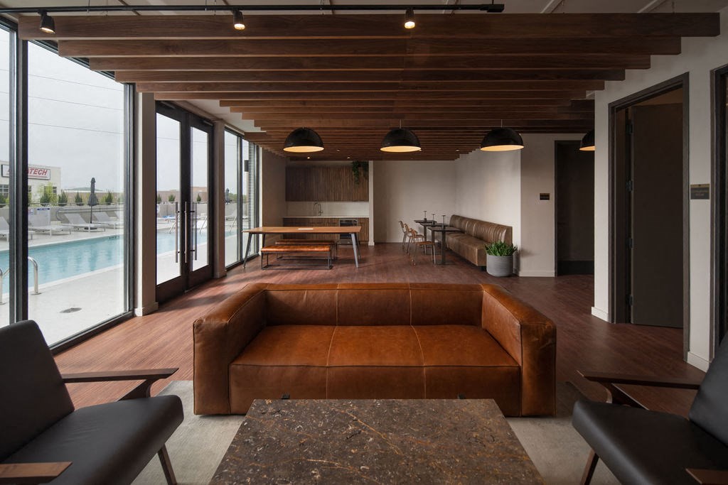 a large living room with a brown couch and a pool