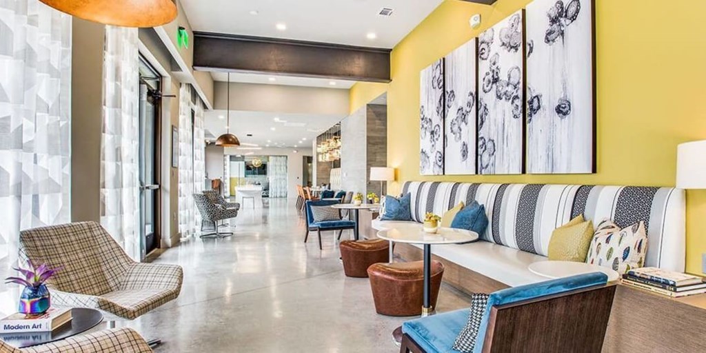 A modern living room with a yellow wall and a sofa.