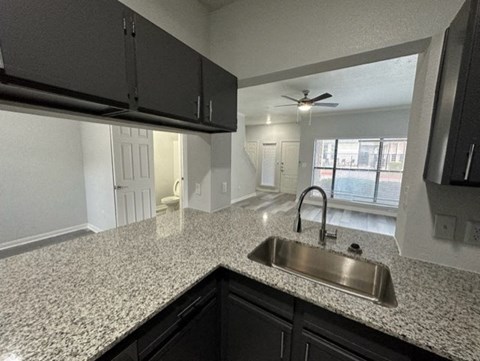 a kitchen with granite counter tops and a sink