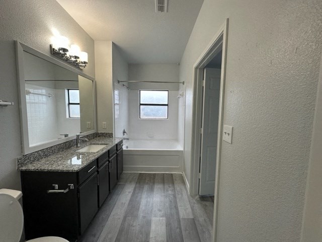 a bathroom with a sink and a toilet and a mirror