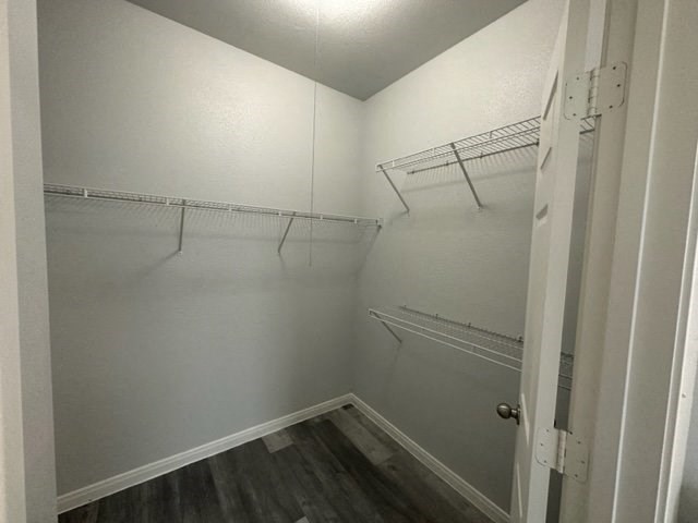 a white closet with empty shelves and a door