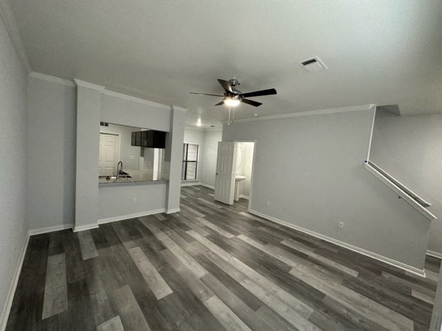 an empty living room with a ceiling fan