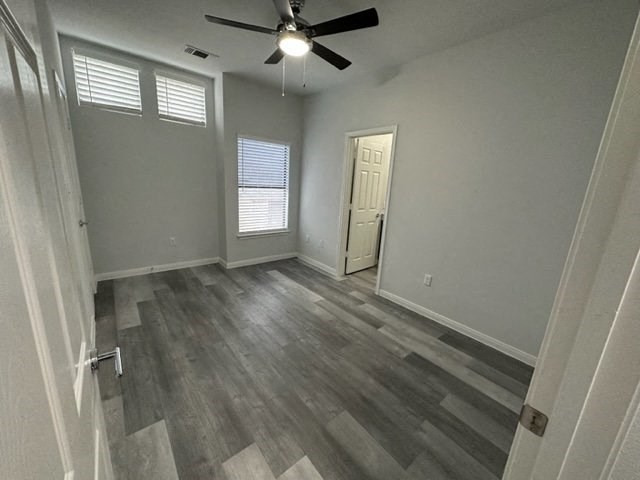 a empty room with a ceiling fan and a door