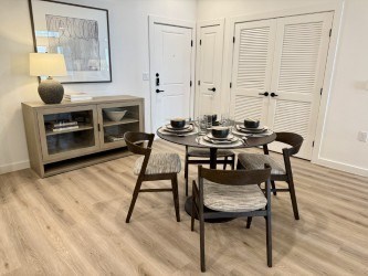 A dining room with a round table and chairs.