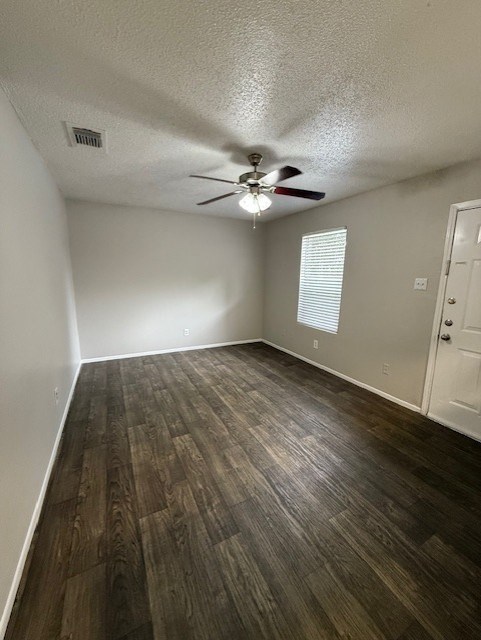 A room with a ceiling fan and wooden flooring.