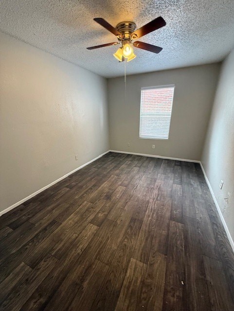 A room with a ceiling fan and wooden flooring.