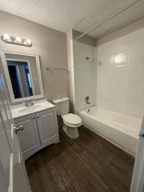 A bathroom with a toilet, sink, and bathtub.