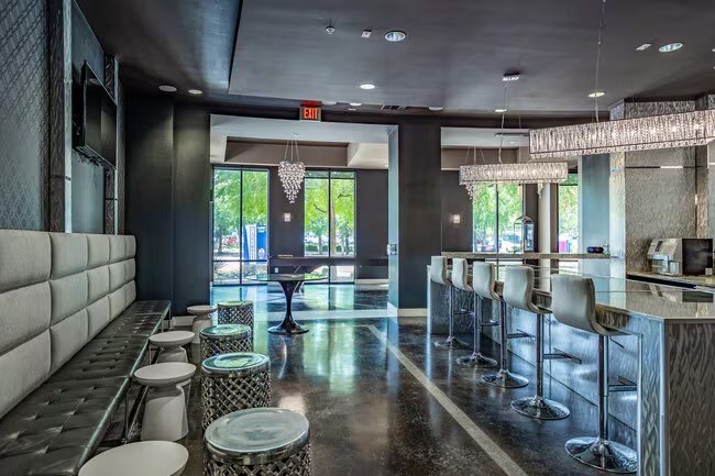 A modern bar with a black and white theme and a view of the outside.