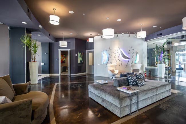 A modern living room with a large couch and a coffee table.