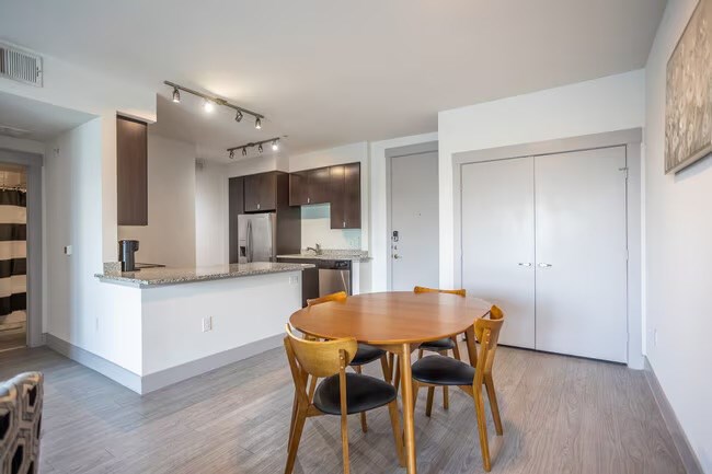 A modern kitchen with a dining table and chairs.