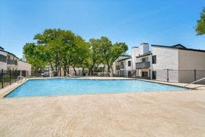 a large pool with trees in the background