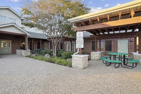 A building with a picnic table in front of it.