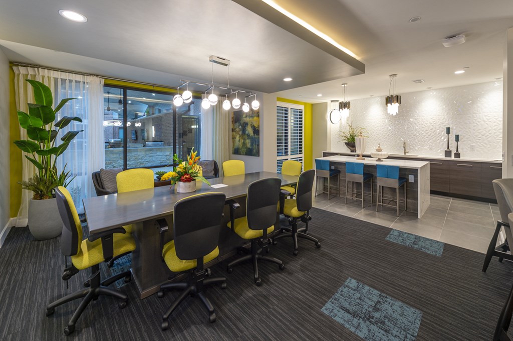 a conference room with a table and chairs and a kitchen