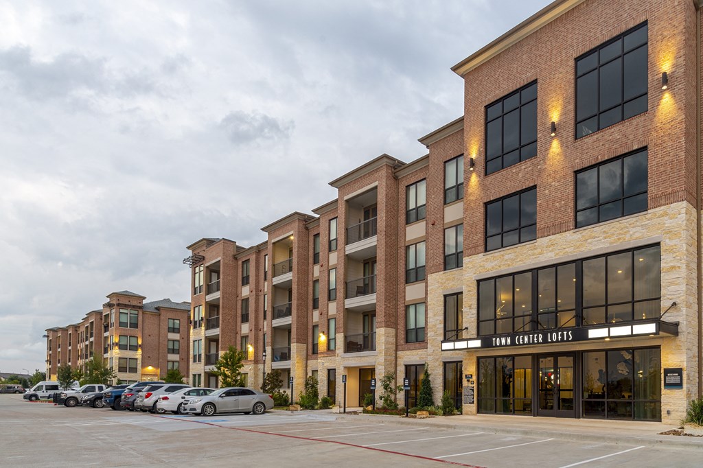 a large brick building with cars parked in front of it