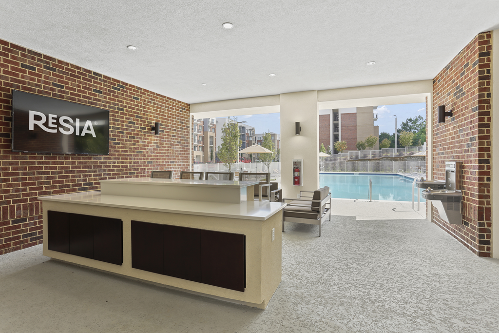 A reception area with a sign that says "RESIA" on the wall.