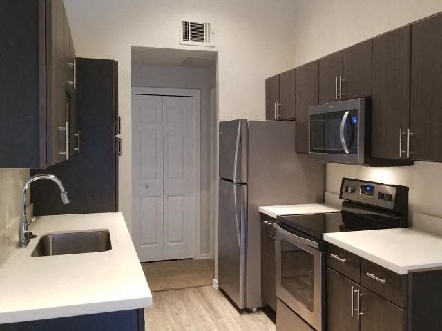 a kitchen with a sink and a refrigerator