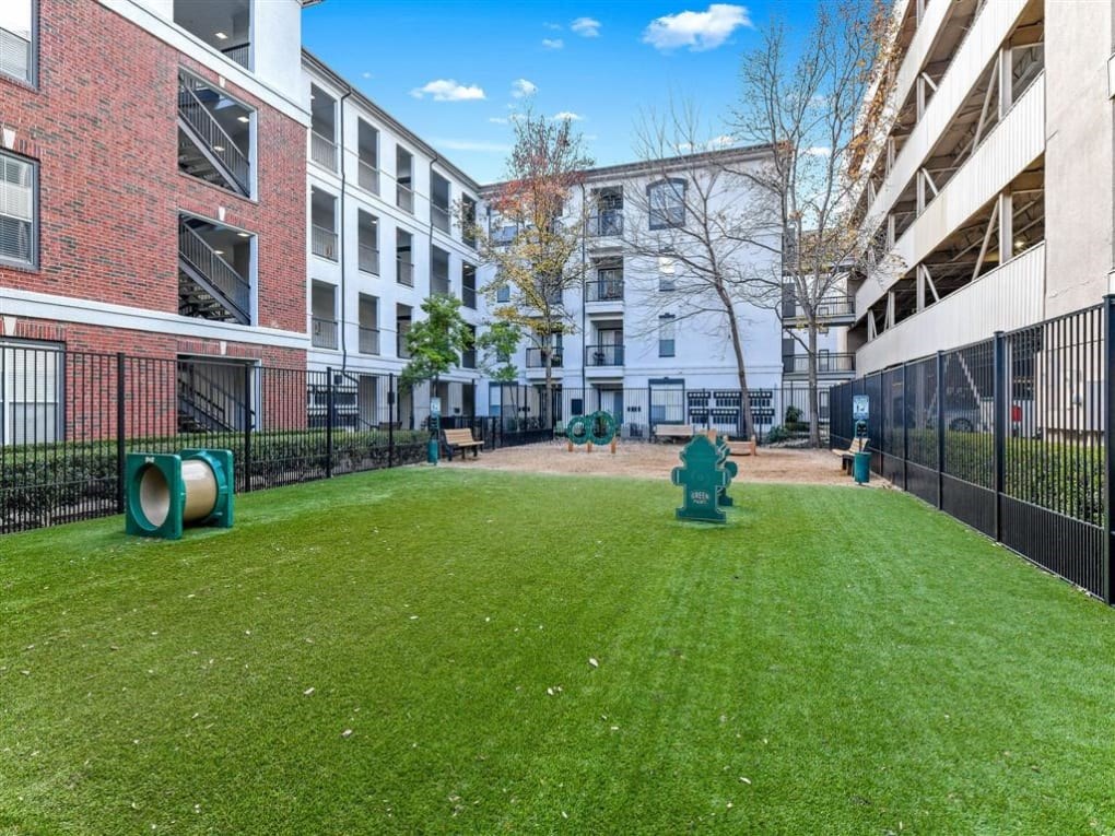 a yard with a fire hydrant in the middle of an apartment building