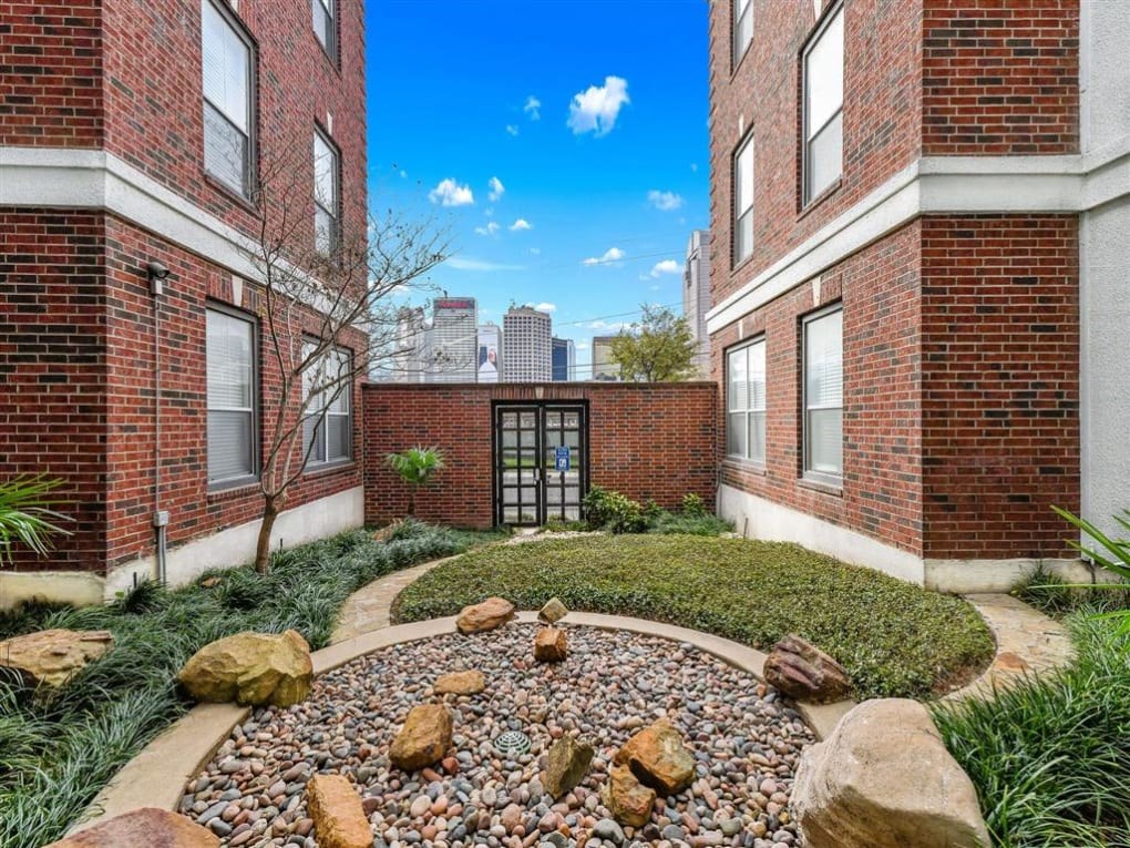 a view of a building with a garden in front of it