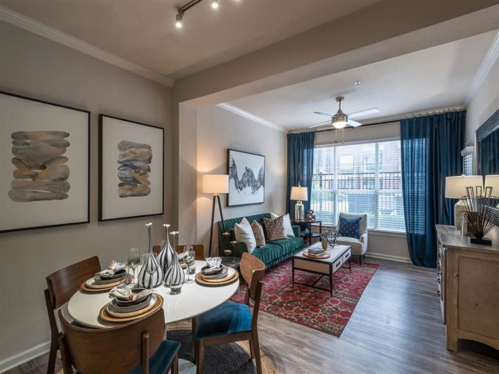 a living room and dining room with a table and chairs