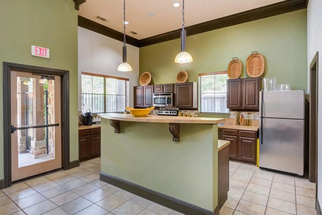 a kitchen with a large island and a refrigerator