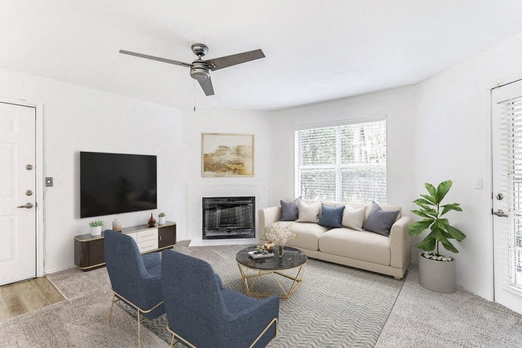a living room with a couch chairs and a tv on the wall