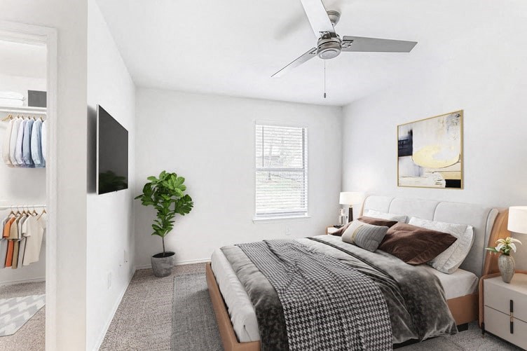a bedroom with a large bed and a ceiling fan