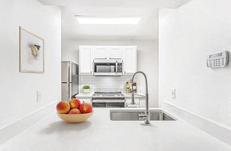 a kitchen with a sink a stove and a microwave