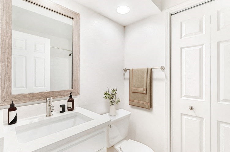 a white bathroom with a white toilet and a white sink