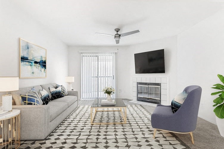 a living room with a fireplace and a tv on the wall