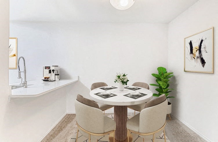 a dining area with a round table and four chairs