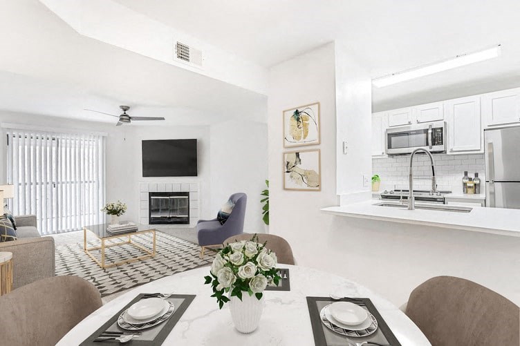 a living room with a table and chairs and a fireplace