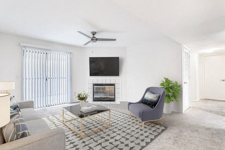 a living room with a fireplace and a tv