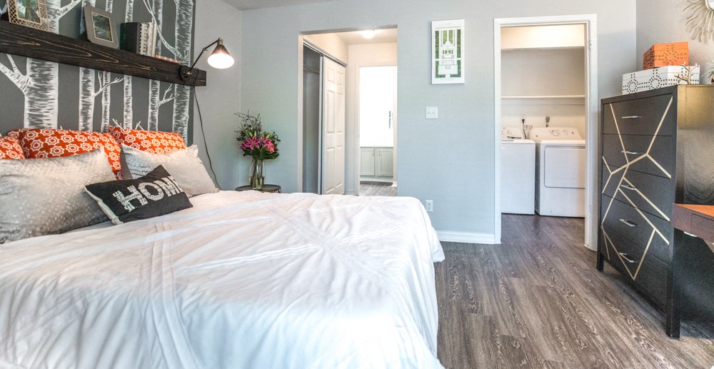 a bedroom with a bed and a dresser