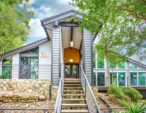 a house with grey siding and an orange front door