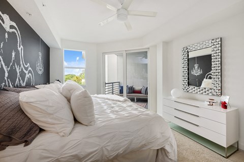 a bedroom with a large bed and a white dresser