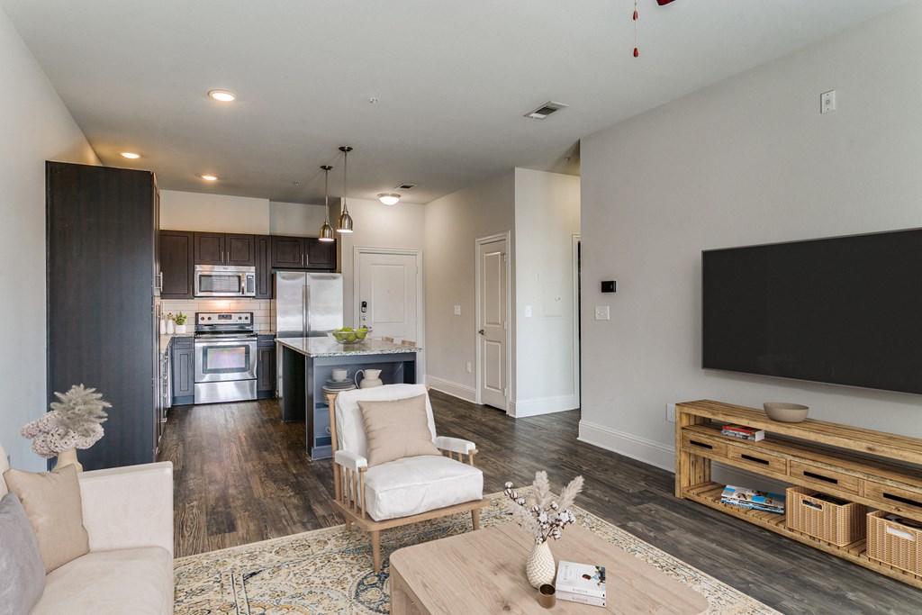 a living room with a tv and a kitchen