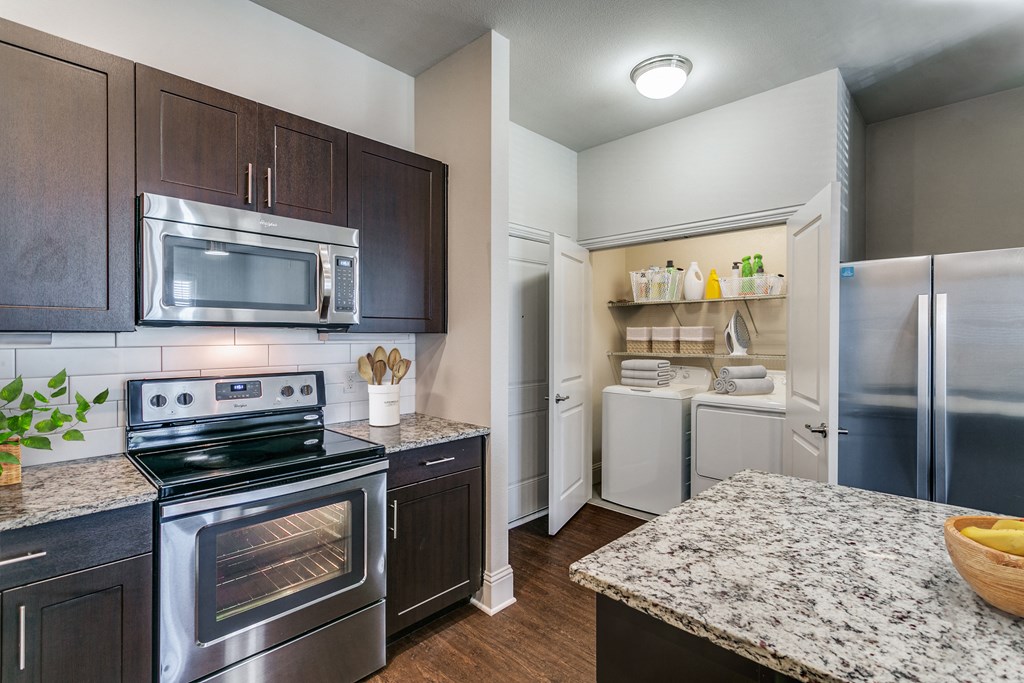 a kitchen with stainless steel appliances and granite counter tops