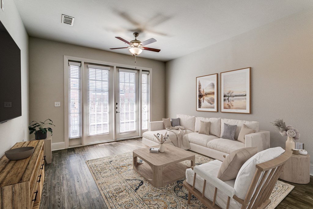 an open living room with a ceiling fan and a couch