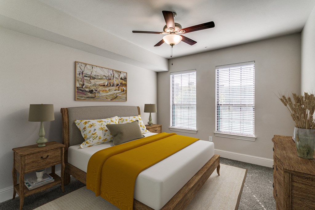 a bedroom with a bed and a ceiling fan
